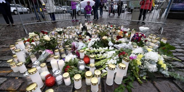 People light memorial candles at the Turku Market Square for the victims of a stabbing spree on August 19, 2017 in Turku.
Police are now investigating a stabbing spree in Finland that left two people dead as a terrorist attack, police said Saturday, identifying the suspect as an 18-year-old Moroccan citizen. / AFP PHOTO / Lehtikuva / Vesa Moilanen / Finland OUT (Photo credit should read VESA MOILANEN/AFP/Getty Images)