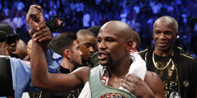 Boxing - Floyd Mayweather Jr. vs Conor McGregor - Las Vegas, USA - August 26, 2017 Floyd Mayweather Jr. celebrates with the belt after winning the fight REUTERS/Steve Marcus