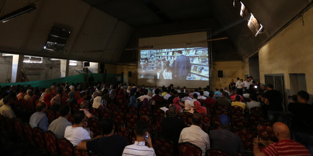 Palestinians attend the screening of "10 Years" at Samer Cinema in Gaza City on August 26, 2017. The Samer Cinema in Gaza City, the oldest in the strip and was built in 1944 but closed for decades, hosted a special screening of a film about Palestinians in Israeli prisons. (Photo by Majdi Fathi/NurPhoto via Getty Images)