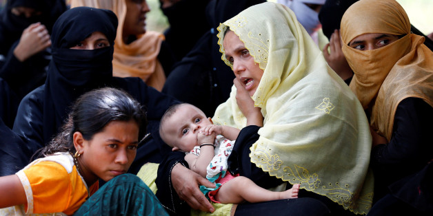 A Rohingya refugee woman with a child talks over phone as she takes shelter in No Manâs Land between Bangladesh-Myanmar border, in Coxâs Bazar, Bangladesh, August 27, 2017. REUTERS/Mohammad Ponir Hossain