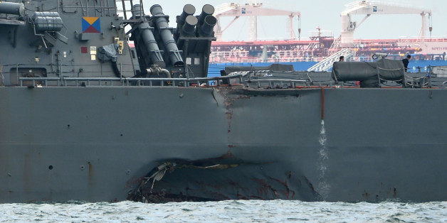 A general view shows the guided-missile destroyer USS John S. McCain with a hole on its left portside after a collision with oil tanker, outside Changi naval base in Singapore on August 21, 2017.
Ten US sailors were missing and five injured early on August 21 after their destroyer collided with a tanker east of Singapore, the second accident involving an American warship in two months. / AFP PHOTO / ROSLAN RAHMAN (Photo credit should read ROSLAN RAHMAN/AFP/Getty Images)