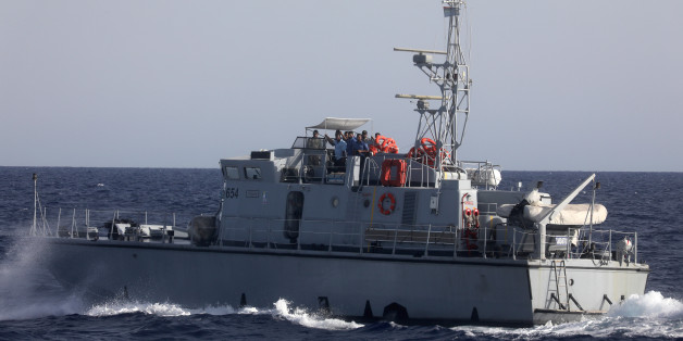 A Libyan coast guard vessel powers next to former fishing trawler Golf Azzurro of the Proactiva Open Arms rescue charity in the Western Mediterranean Sea August 15, 2017. REUTERS/Yannis Behrakis