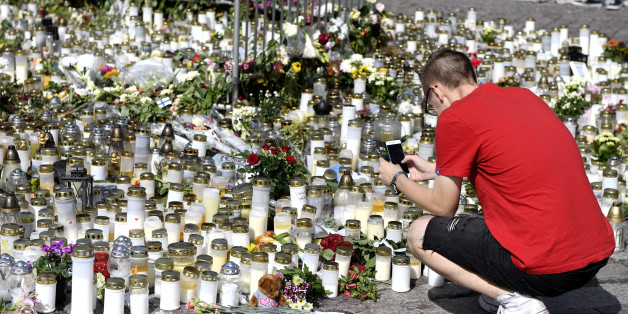 Mourners bring memorial cards, candles and flowers to the Turku Market Square, in Turku, Finland August 20, 2017. Lehtikuva/Vesa Moilanen/via ATTENTION EDITORS - THIS IMAGE WAS PROVIDED BY A THIRD PARTY. FINLAND OUT.