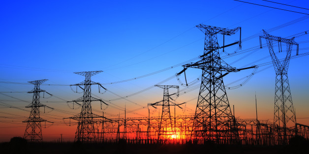 The silhouette of the evening electricity transmission pylon