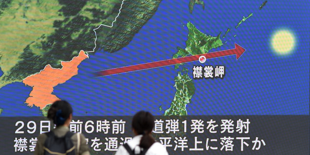 Des passants regardent le 29 août 2017 à Tokyo un écran montrant la carte du Japon et de la péninsule coréenne, d'où est parti le missile qui a survolé l'archipel / (Photo credit should read TOSHIFUMI KITAMURA/AFP/Getty Images)