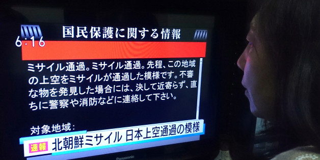 A woman looks at a television news displaying warnings via the 'J-alert' system in Tokyo on August 29, 2017, following a North Korean missile test that passed over Japan. Japanese Prime Minister Shinzo Abe said on August 29 that he and US President Donald Trump agreed to hike pressure on North Korea after it launched a ballistic missile over Japan, in Pyongyang's most serious provocation in years. / AFP PHOTO / Kazuhiro NOGI (Photo credit should read KAZUHIRO NOGI/AFP/Getty Images)