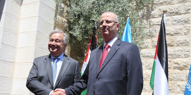 RAMALLAH, WEST BANK - AUGUST 29: United Nations Secretary General Antonio Guterres (L) shakes hands with Prime Minister of Palestine Rami Hamdallah (R) as they pose for a photo during an official ceremony at Prime Ministry building due to Guterres' official visit in Ramallah, West Bank on August 29, 2017. (Photo by Issam Rimawi/Anadolu Agency/Getty Images)