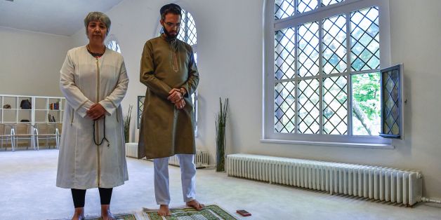 Openly gay French imam Ludovic-Mohamed Zahed (R) and German-Turkish lawyer, author and activist Seyran Ates (L) pose for photographers prior to Friday prayers at the Ibn Rushd-Goethe-mosque in Berlin on July 28, 2017.Zaher, who opened the first gay-friendly mosque in France in 2012, visited the Ibn Rushd-Goethe-mosque founded by Seyran Ates, which aims to establish a humanistic, secular and liberal reading of Islam. / AFP PHOTO / John MACDOUGALL (Photo credit should read JOHN MACDOUGALL/A