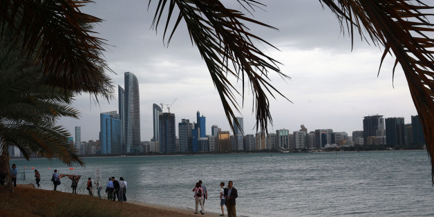 Tourists gather at Abu Dhabi sea front before a heavy rain storm on March 9, 2016.Schools in the United Arab Emirates were ordered to shut after rare heavy rain hit the desert Gulf state, causing flights to be suspended and flooding roads. / AFP / STRINGER (Photo credit should read STRINGER/AFP/Getty Images)