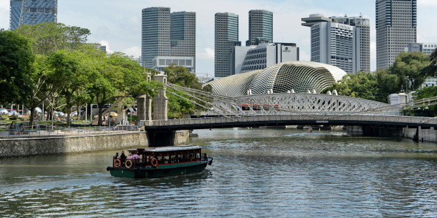 Tourists ride a boat touring along a river in Singapore on January 4, 2016. Singapore's trade-dependent economy grew by an estimated 2.1 percent in 2015, its worst performance since the 2009 recession, as global demand for Asian exports slumped, official data showed on January 4. AFP PHOTO / ROSLAN RAHMAN / AFP / ROSLAN RAHMAN (Photo credit should read ROSLAN RAHMAN/AFP/Getty Images)