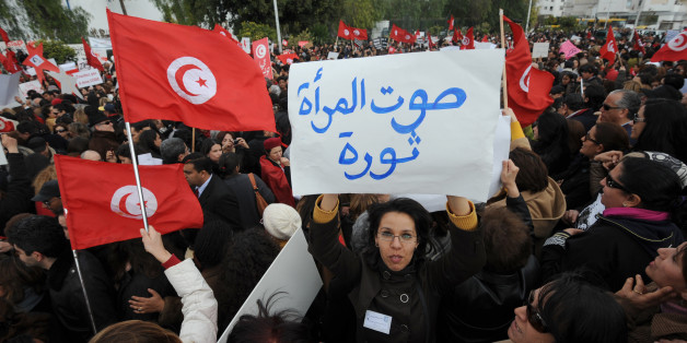 Tunisian women display placards during a protest on International Women's Day in Tunis on March 8, 2012. The legal status of women in Tunisia is unique in the Arab world giving strict equality between men and women since since 1956. AFP PHOTO / FETHI BELAID (Photo credit should read FETHI BELAID/AFP/Getty Images)