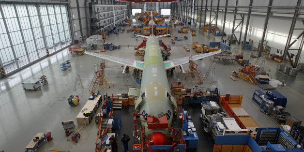 Employees work on the fuselages of three Airbus aircraft inside a hangar at the company's production plant in Hamburg, Germany, on Tuesday, Jan. 17, 2012. Airbus SAS, a unit of European Aeronautic, Defence & Space Co., delivered a record 534 planes, ahead of budget, and predicted deliveries will rise to 570 aircraft in 2012. Photographer: Michele Tantussi/Bloomberg via Getty Images