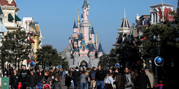 Visitors walk towards the Sleeping Beauty Castle in Disneyland Paris ahead of the 25th anniversary of the park in Marne-la-Vallee, near Paris, France, March 16, 2017. Picture taken March 16, 2017. REUTERS/Benoit Tessier