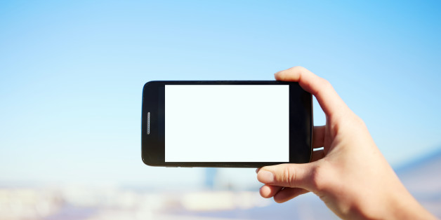Female hand holding smartphone with blank copy space area for your text message or content,tourist woman holding cell phone while taking a photograph of landscape in summer travel,empty digital screen