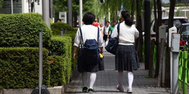 Japanese schoolgirls walk on a street in Tokyo on September 1, 2017.As Japan's schools reopened Friday after summer holidays, a day when suicides among young people spike, celebrities reached out to at-risk kids and one Tokyo zoo offered refuge to petrified pupils in a bid to tackle the mental health crisis. For some schoolkids, the thought of returning to school sends their stress levels soaring, as they battle fears ranging from schoolyard bullies to doing poorly on exams. / AFP PHOTO / Toru Y
