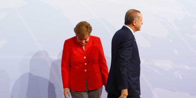 HAMBURG, GERMANY - JULY 07: German Chancellor Angela Merkel (L) welcomes Turkish President Recep Tayyip Erdogan (R) for a family photo taking during G20 (Group of 20) leaders' summit in Hamburg, Germany on July 7, 2017. Germany is hosting leaders from the worlds 20 largest economies at the Hamburg summit on July 7-8, set to focus on the global economy, trade, climate change, and the fight against international terrorism. (Photo by Michele Tantussi/Anadolu Agency/Getty Images)