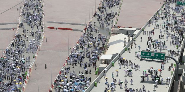 Muslim pilgrims, some holding umbrellas to protect themselves from the sun, head to take part in the symbolic stoning of the devil at the Jamarat Bridge in Mina, near Mecca, which marks the final major rite of the hajj on September 1, 2017. / AFP PHOTO / KARIM SAHIB (Photo credit should read KARIM SAHIB/AFP/Getty Images)