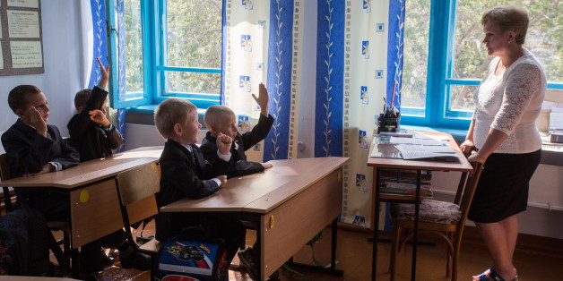 OMSK REGION, RUSSIA - SEPTEMBER 1, 2017: First grade students listen to a teacher at a lesson on Knowledge Day, a Russian hoiday marking the beginning of a new academic year, at a rural school in the village of Neidorf, Maryanovsky District. Dmitry Feoktistov/TASS (Photo by Dmitry Feoktistov\TASS via Getty Images)