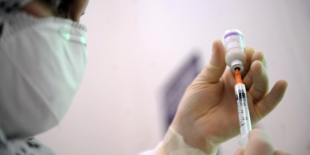 An Algerian doctor prepares a vaccine dose against the H1N1 flu at 'Beni Mesouss' hospital, on December 30, 2009 in Algiers. Algeria launched a national swine flu vaccination campaign on Wednesday. The vaccination campaign will be carried out in six phases to cover public and private health personnel, pregnant women, staff involved in core and strategic activities, all patients suffering from chronic diseases, children and teenagers over six months to 14 years of age, announced the Ministry of