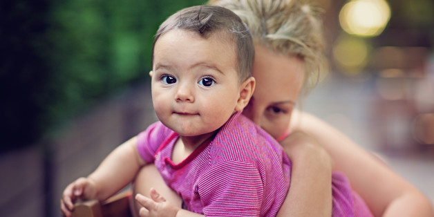 Mother is hugging her baby