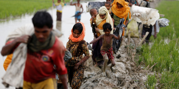 Rohingya refugees walk on the muddy path after crossing the Bangladesh-Myanmar border in Teknaf, Bangladesh, September 3, 2017. REUTERS/Mohammad Ponir Hossain