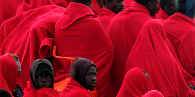 Migrants, who were part of a group intercepted aboard a dinghy off the coast in the Mediterranean sea, wrapped in blankets on a rescue boat upon arriving at a port in Malaga, southern Spain, December 3, 2016. REUTERS/Jon Nazca