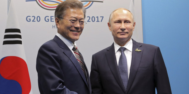 Russia's President Vladimir Putin (R) shakes hands with South Korea's President Moon Jae-in during a meeting on the sidelines of the G20 summit in Hamburg, Germany July 7, 2017 Sputnik/Mikhail Klimentyev/Kremlin via REUTERS ATTENTION EDITORS - THIS IMAGE WAS PROVIDED BY A THIRD PARTY. EDITORIAL USE ONLY.
