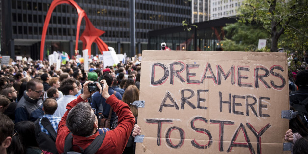 A demonstrator displays a placard outside the Federal Plaza while protesting the end of the Deferred Action for Childhood Arrivals (DACA) program in Chicago, Illinois, U.S., on Tuesday, Sept. 5, 2017. President Donald Trump will end an Obama-era program preventing the deportation of immigrants illegally brought to the U.S. as children, U.S. Attorney Jeff Sessions said today, putting in legal limbo about 1 million people who consider themselves Americans. Photographer: Christopher Dilts/Bloomberg