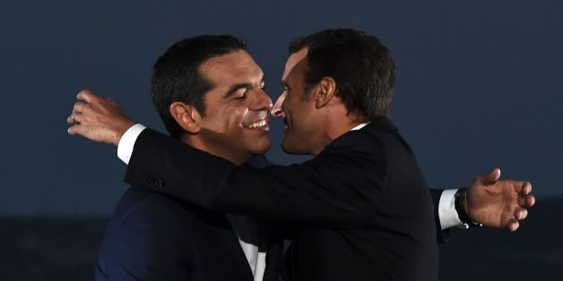 French president Emmanuel Macron (R) embraces Greek Prime Minister Alexis Tsipras as he arrives to deliver a speech on the Pnyx hill with the Acropolis in the backround in Athens on September 7, 2017, as part of his two-day official visit to Greece.
Macron was holding talks on September 7 with Greek Prime Minister Alexis Tsipras and President Prokopis Pavlopoulos. / AFP PHOTO / ARIS MESSINIS (Photo credit should read ARIS MESSINIS/AFP/Getty Images)