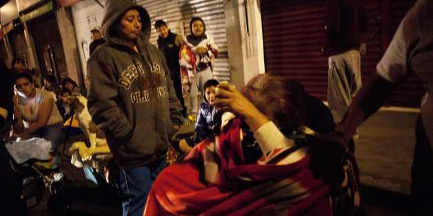 People gather on a street in the Tlatelolco neigborhood of Mexico City during an earthquake on September 7, 2017.An earthquake of magnitude 8.0 struck southern Mexico late Thursday and was felt as far away as Mexico City, the US Geological Survey said, issuing a tsunami warning. It hit offshore 120 kilometers (75 miles) southwest of the town of Tres Picos in the state of Chiapas. / AFP PHOTO / PEDRO PARDO (Photo credit should read PEDRO PARDO/AFP/Getty Images)