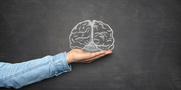 Brain and hand front of blackboard