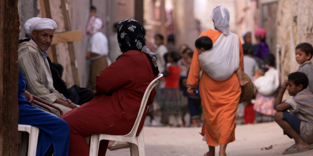 A Moroccan woman carries a young child in a sling on her back as she
walks along one of the many narrow streets in Marrakech, November 6,
2001. REUTERS/Zohra Bensemra
JES/