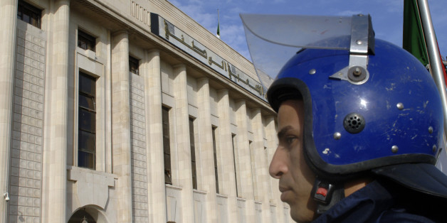 An Algerian policeman stands guard outside the People's National Assembly bulding in the capital Algiers on November 27, 2016. / AFP / RYAD KRAMDI (Photo credit should read RYAD KRAMDI/AFP/Getty Images)