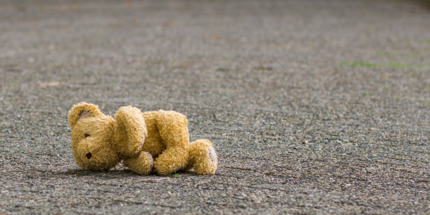 Teddy bear lies on the road