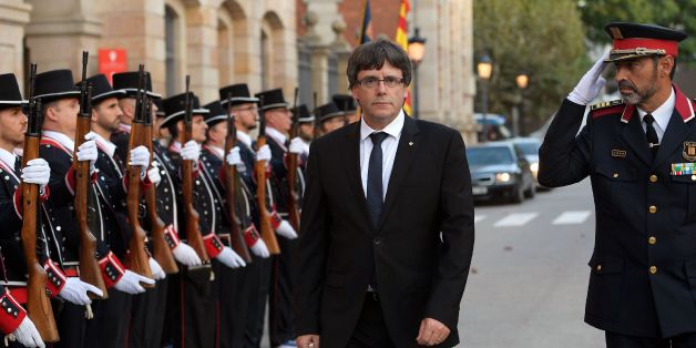 President of the Catalan regional government Carles Puigdemont (2R) and Josep Lluis Trapero (R), chief of the Catalan regional police, inspect the Mossos D'Esquadra troops before attending an institutional ceremony to award the Mossos d'Esquadra (Catalan regional police), the Barcelona Local Police, the Cambrils Local Police and the emergency services with the Parliament's Medal of Honour on September 10, 2017 in Barcelona.Pro-independence protesters are due to come out in force in the streets o