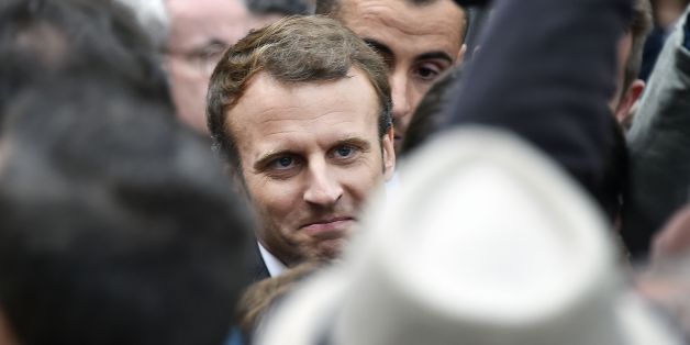 French President Emmanuel Macron (C) walks surrounded by members of the presidential security service, at the Place du Capitole in Toulouse, southern France, before attending the round table on 'Housing First', on September 11, 2017.
This visit took place on the eve of the first general strike in protest against a the new Labor Reform Act. / AFP PHOTO / PASCAL PAVANI (Photo credit should read PASCAL PAVANI/AFP/Getty Images)
