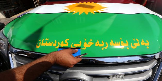 An Iraqi Kurdish man decorates a car with the Kurdish flags ahead of the upcoming independence referendum in Arbil, the capital of the autonomous Kurdish region of northern Iraq, on September 7, 2017. Iraq's autonomous Kurdish region will hold a historic referendum on statehood in September 2017, despite opposition to independence from Baghdad and possibly beyond. / AFP PHOTO / SAFIN HAMED (Photo credit should read SAFIN HAMED/AFP/Getty Images)