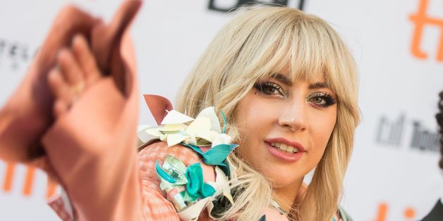 Lady Gaga and Chris Moukarbel pose for photographers as they arrive for the premiere of their movie 'Gaga: Five Foot Two' at the Toronto International Film Festival in Toronto, Ontario, September 8, 2017. / AFP PHOTO / Geoff Robins (Photo credit should read GEOFF ROBINS/AFP/Getty Images)