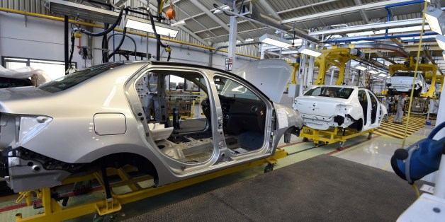 Employees of the French car maker Renault group work on a new production line during its inauguration on November 10, 2014, in Oued Tlelat in the south of the Algerian city of Oran. The factory is to produce the Symbol, a saloon based on Renault's Clio compact sold mainly in markets where hatchbacks are not traditionally favoured. Production is destined for the Algerian market, Africa's second largest in terms of sales, with more than 400,000 vehicles imported every year. AFP PHOTO / FAROUK BATICHE (Photo credit should read FAROUK BATICHE/AFP/Getty Images)