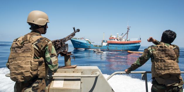 Libyan coastguards stand on an armoured boat as they patrol the area at sea between Sabratha and Zawiyah on July 28, 2017. / AFP PHOTO / TAHA JAWASHI (Photo credit should read TAHA JAWASHI/AFP/Getty Images)