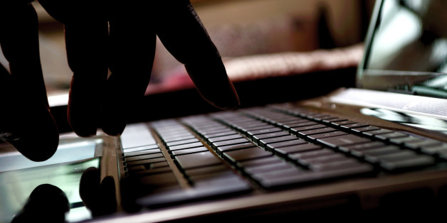 cyber crime hacker typing on laptop