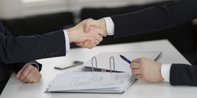 Berlin, Germany - March 23: In this Photo Illustration two people shaking hands on a table with documents of an apartment on March 23, 2016 in Berlin, Germany. (Photo Illustration by Thomas Trutschel/Photothek via Getty Images)