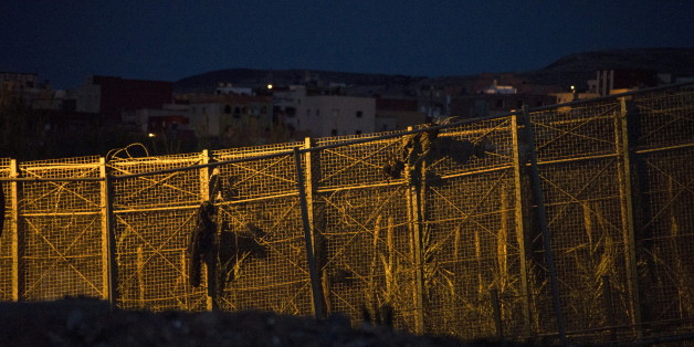 Belongings of African migrants hang from a border fence after their attempt to cross into Spanish territories, between Morocco and Spain's north African enclave of Melilla, Spain, February 18, 2016. REUTERS/Jesus Blasco de Avellaneda