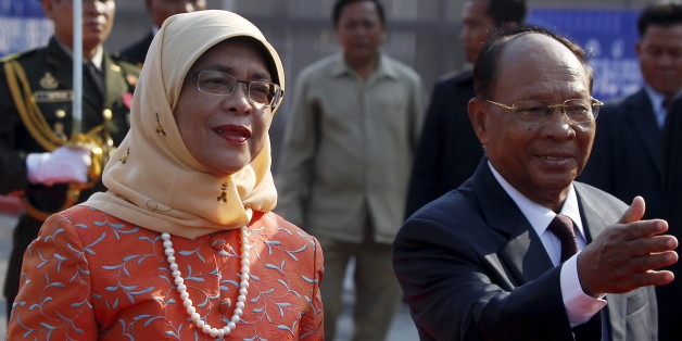 Halimah Yacob (L), Speaker of the Parliament of Singapore inspects the honour guard, accompanied by Cambodia's President of the National Assembly Heng Samrin (R) during an official welcoming ceremony in front of the Cambodian National Assembly in Phnom Penh May 7, 2015. Yacob is on a three-day visit to Cambodia. REUTERS/Samrang Pring