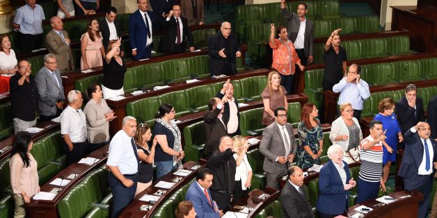 Members of Tunisia's Nidaa Tounes party celebrate after a contested reconciliation bill was adopted granting amnesty to officials accused of corruption during the rule of the former regime, in Tunis on September 13, 2017.
/ AFP PHOTO / FETHI BELAID (Photo credit should read FETHI BELAID/AFP/Getty Images)
