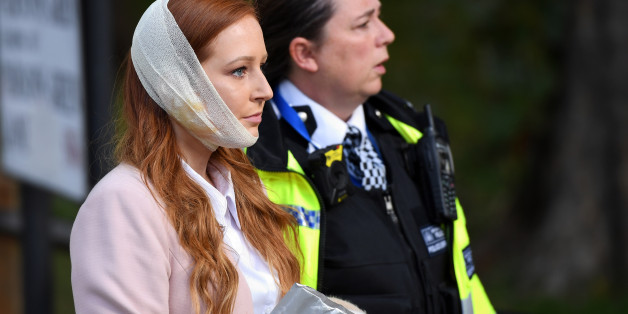 LONDON, ENGLAND - SEPTEMBER 15: A police officer escorts an injured woman from the scene at Parsons Green Underground Station on September 15, 2017 in London, England. Several people have been injured after an explosion on a tube train in south-west London. The Police are treating the incident as terrorism. (Photo by Chris J Ratcliffe/Getty Images)