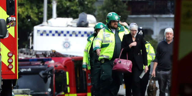 An injured woman is led away after an incident at Parsons Green underground station in London, Britain, September 15, 2017. REUTERS/Luke MacGregor