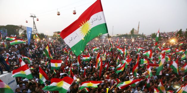 TOPSHOT - Iraqi Kurds fly Kurdish flags during an event to urge people to vote in the upcoming independence referendum in Arbil, the capital of the autonomous Kurdish region of northern Iraq, on September 16, 2017. / AFP PHOTO / SAFIN HAMED (Photo credit should read SAFIN HAMED/AFP/Getty Images)