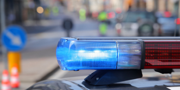 Blue flashing sirens of police car during the roadblock in the city