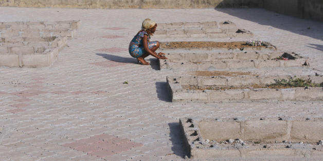 A girl kneels near the graves of victims of a suicide bomb attack at St. Theresa's Church in Madalla, on the outskirts of Nigeria's capital Abuja December 23, 2012. Boko Haram has killed hundreds in its campaign to impose sharia law in northern Nigeria and is the biggest threat to stability in Africa's top oil exporter.This Christmas, the police and military are expecting more trouble in the north. They've ordered security to be tightened, people's movement restricted and churches to be guarded.